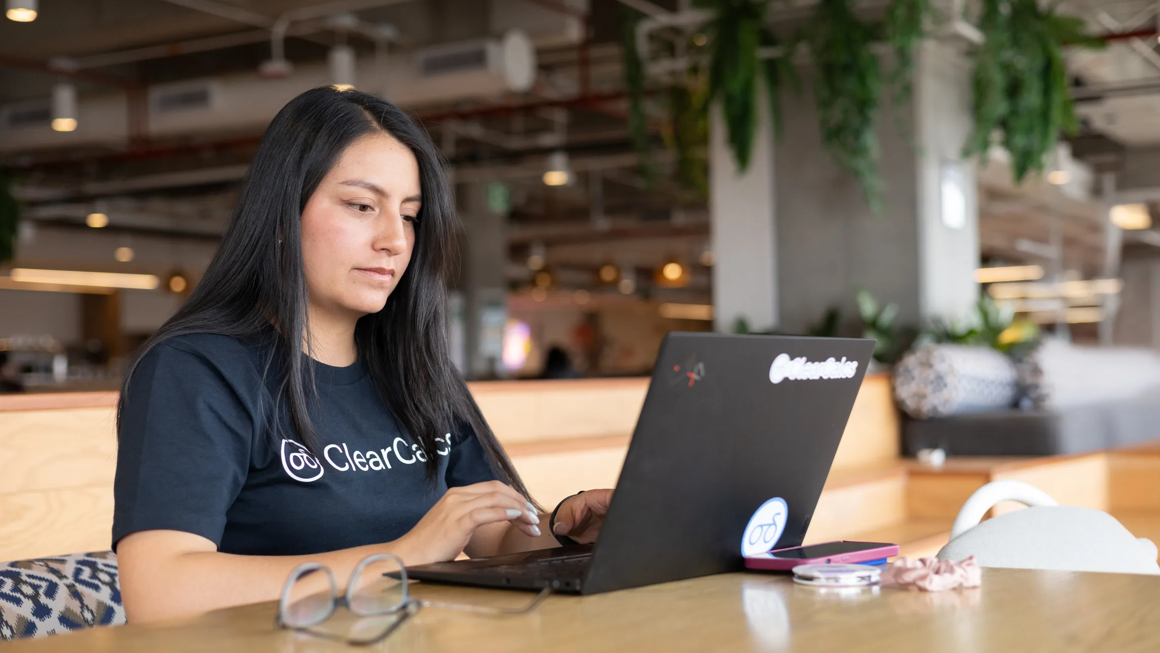 A Calcs.com engineer working at a laptop in the Bogota office