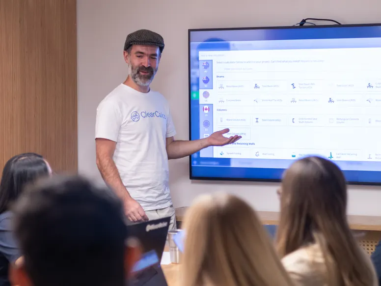 A ClearCalcs team member presenting the calculator library on a screen to colleagues in the Bogota office